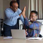 Smiling,African,American,Male,Colleagues,Give,High,Five,Celebrate,Shared