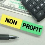 Calculators,,Pens,,Banknotes,And,Colored,Boards,With,The,Word,Non